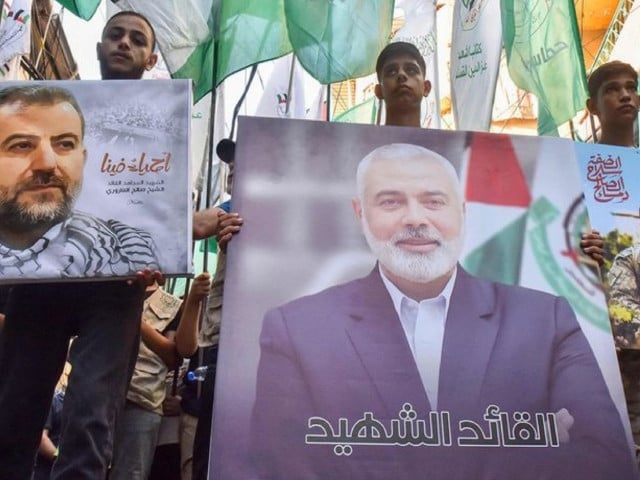 demonstrators wave flags and hold pictures of the leader of the palestinian militant hamas group ismail haniyeh c and senior leader saleh al arouri during a protest on july 31 2024 in beirut s burj al barajneh camp for palestinian refugees denouncing his killing photo afp
